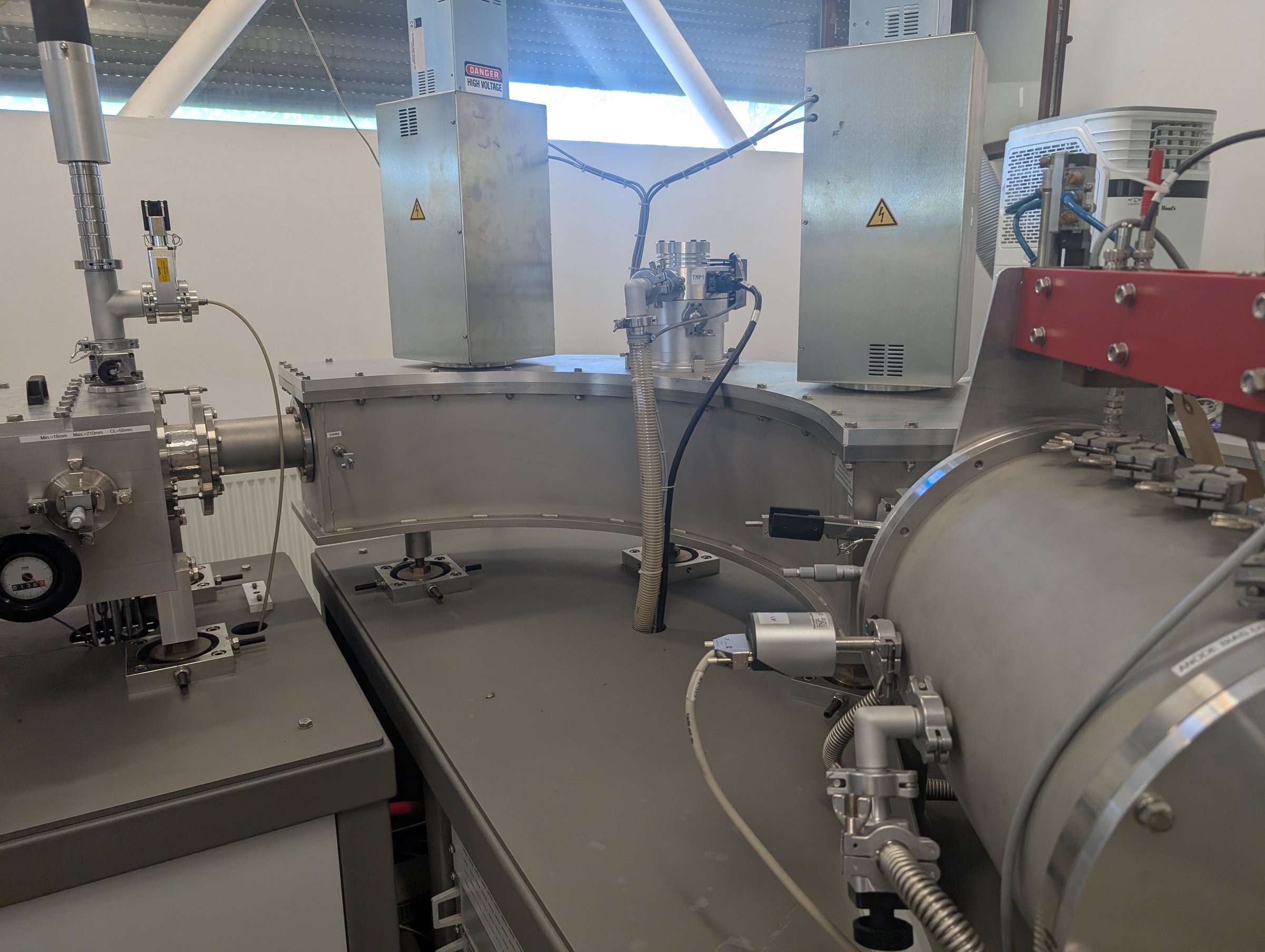 The 120-degree high-energy electrostatic analyser of the 1 MV AMS — flat cylindrical chamber with two high-voltage feedthrough towers on the detection bench