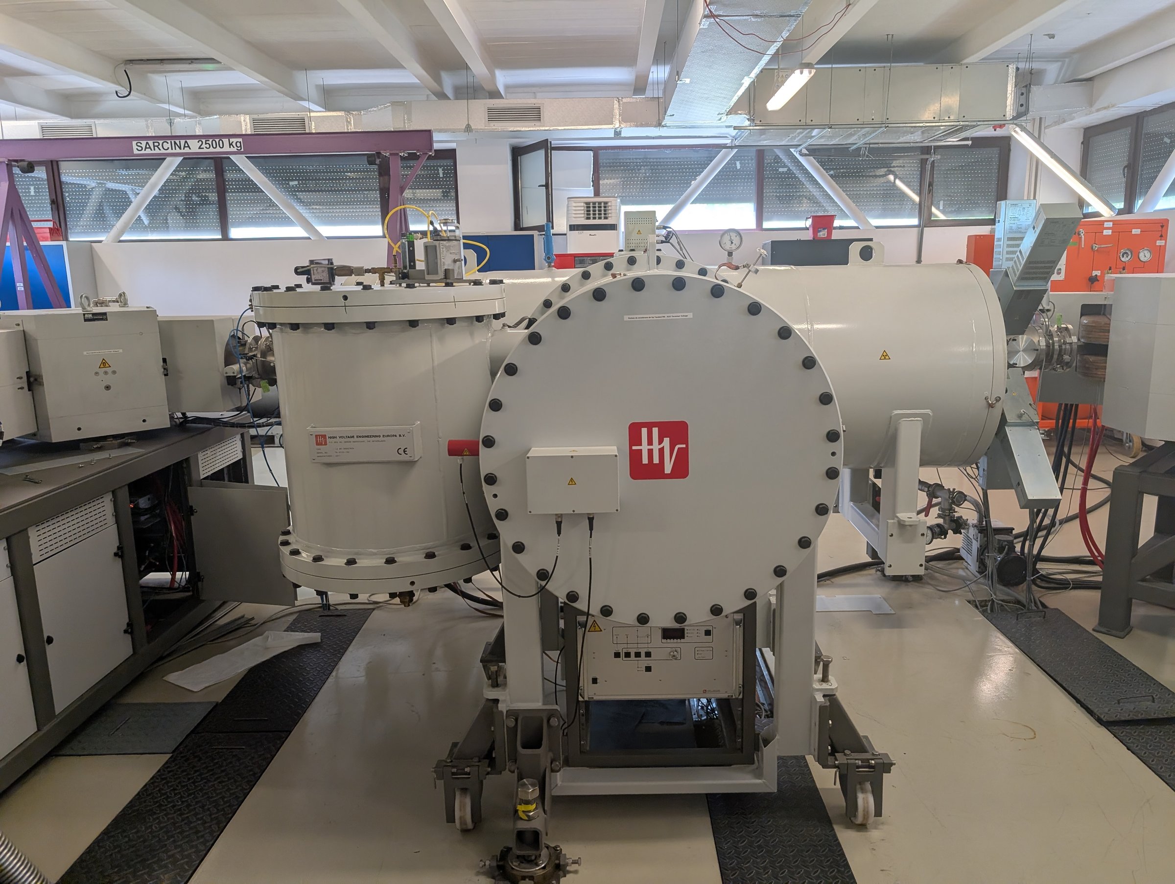Side view of the 1 MV HVEE Cockcroft-Walton Tandetron accelerator tank in the experimental hall at IFIN-HH