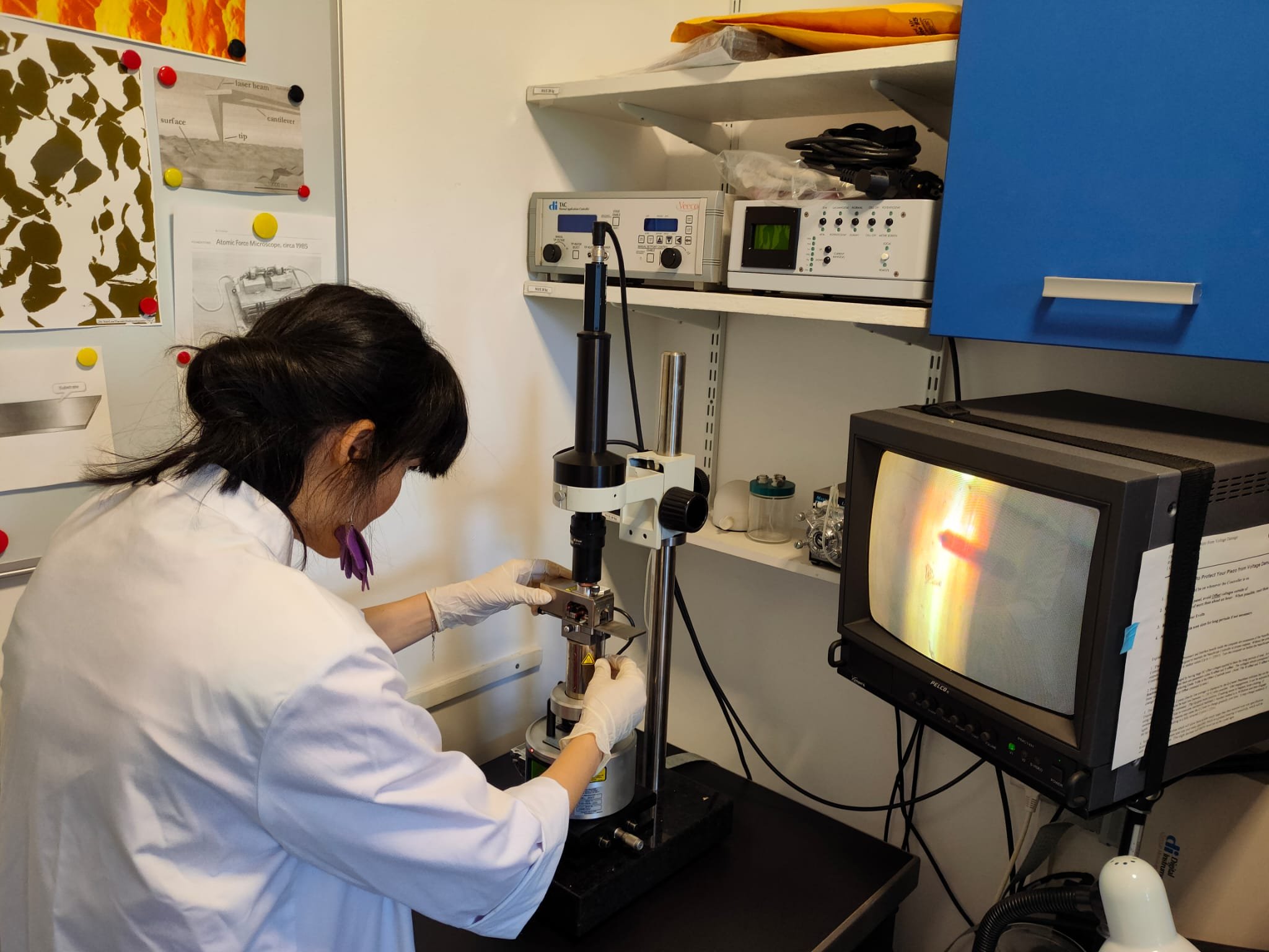 Researcher at the MultiMode NanoScope III A AFM in the NANOMAT laboratory, with controller, optical camera and CRT monitor