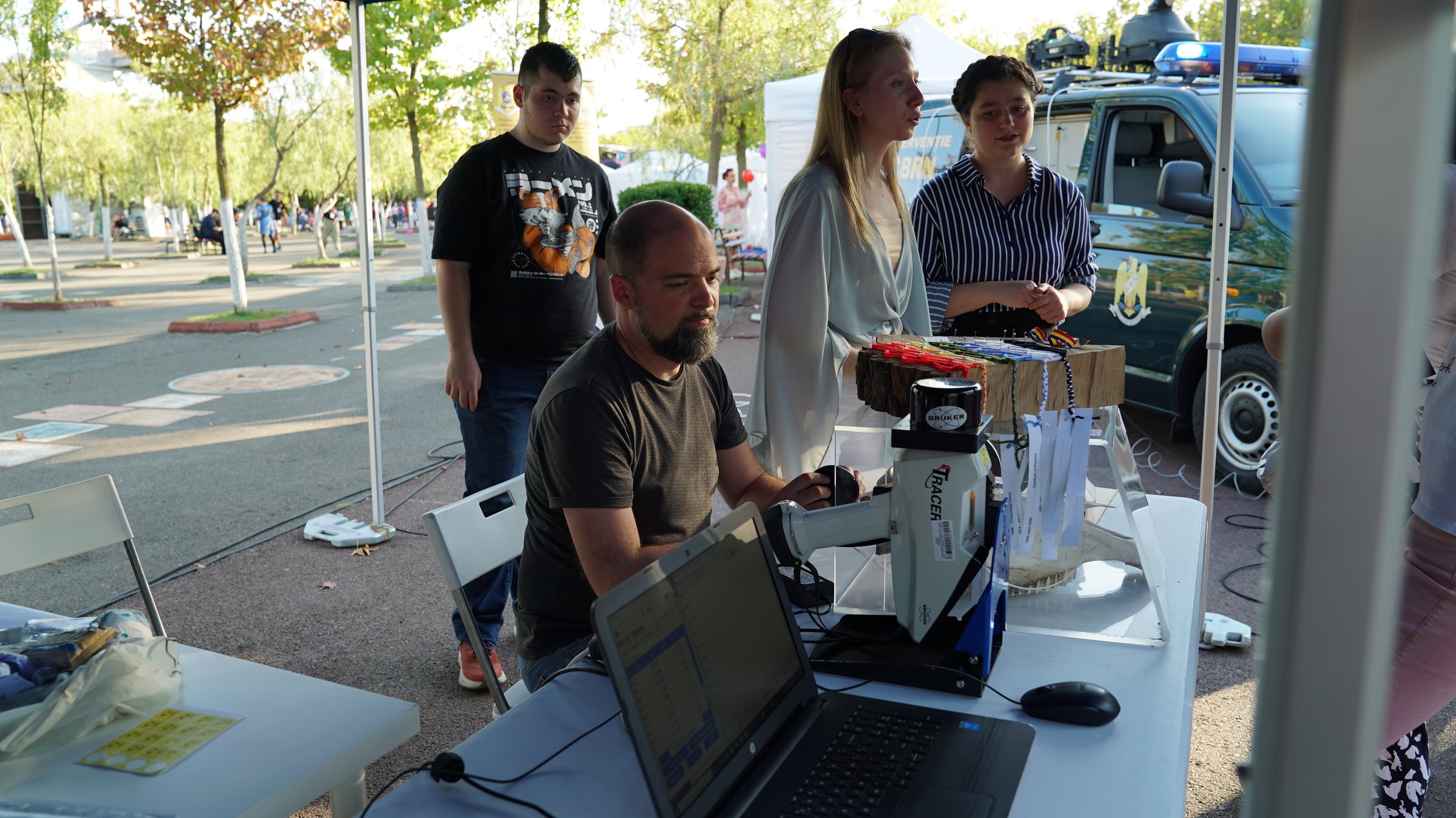 The portable Bruker Tracer EDXRF analyser in use at a public outreach event, analysing samples on the spot