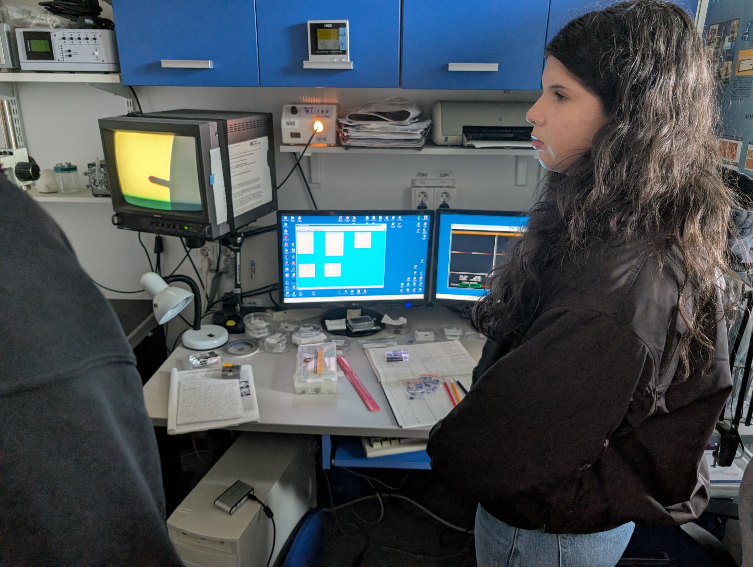 A visiting student at the AFM control desk watching a live scan on the monitors at TIESR