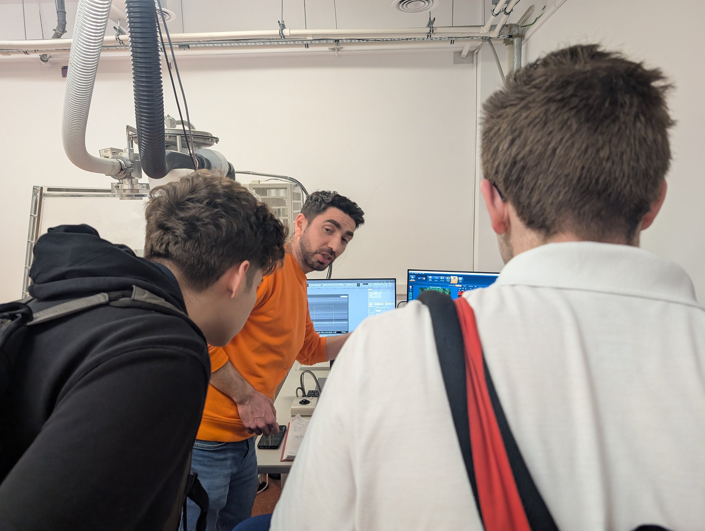 A DFNA researcher explaining an instrument to visiting students at TIESR