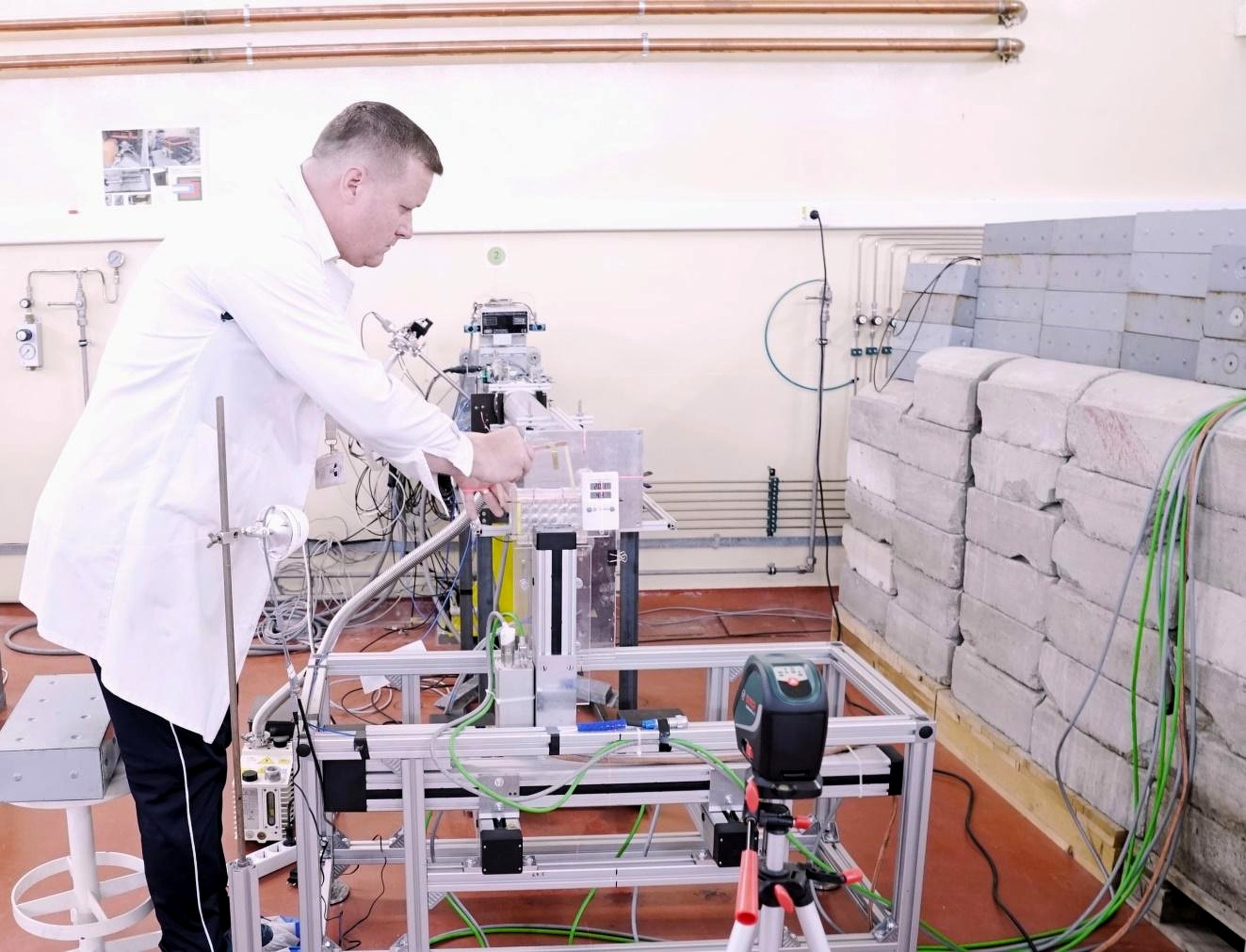 The experimental proton radiobiology line in the TR-19 hall: an automated precision-positioning frame in front of the external beam line, with concrete shielding alongside