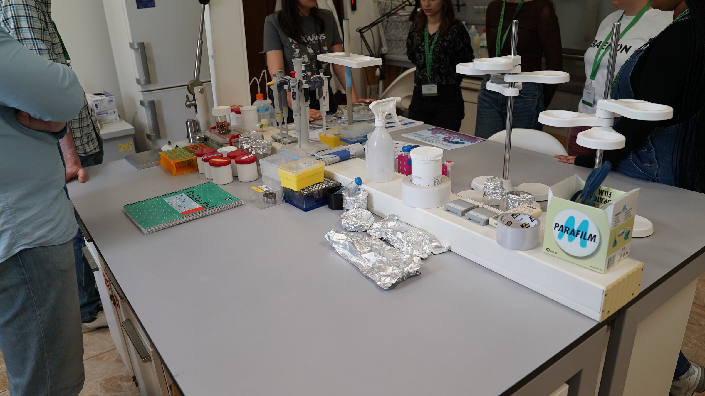 Students gathered around the sample-preparation bench during a lab visit