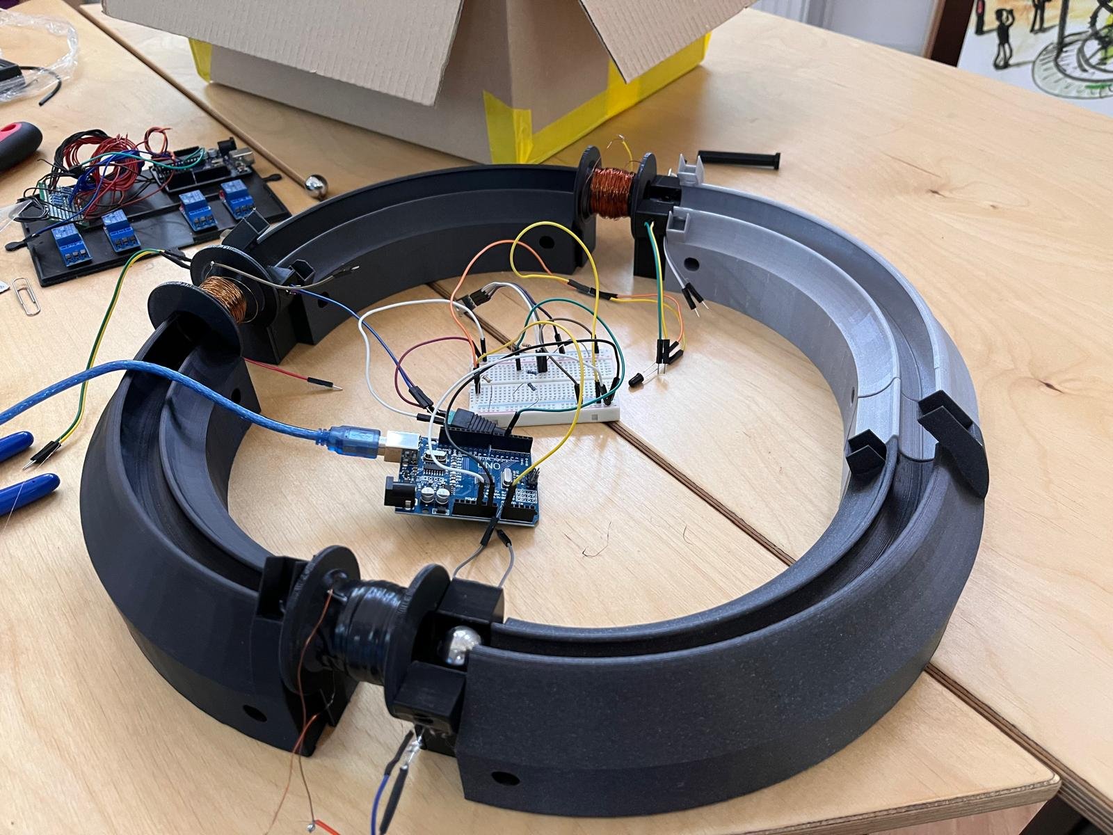 The multistage coil accelerator model under construction, with coils and Arduino electronics