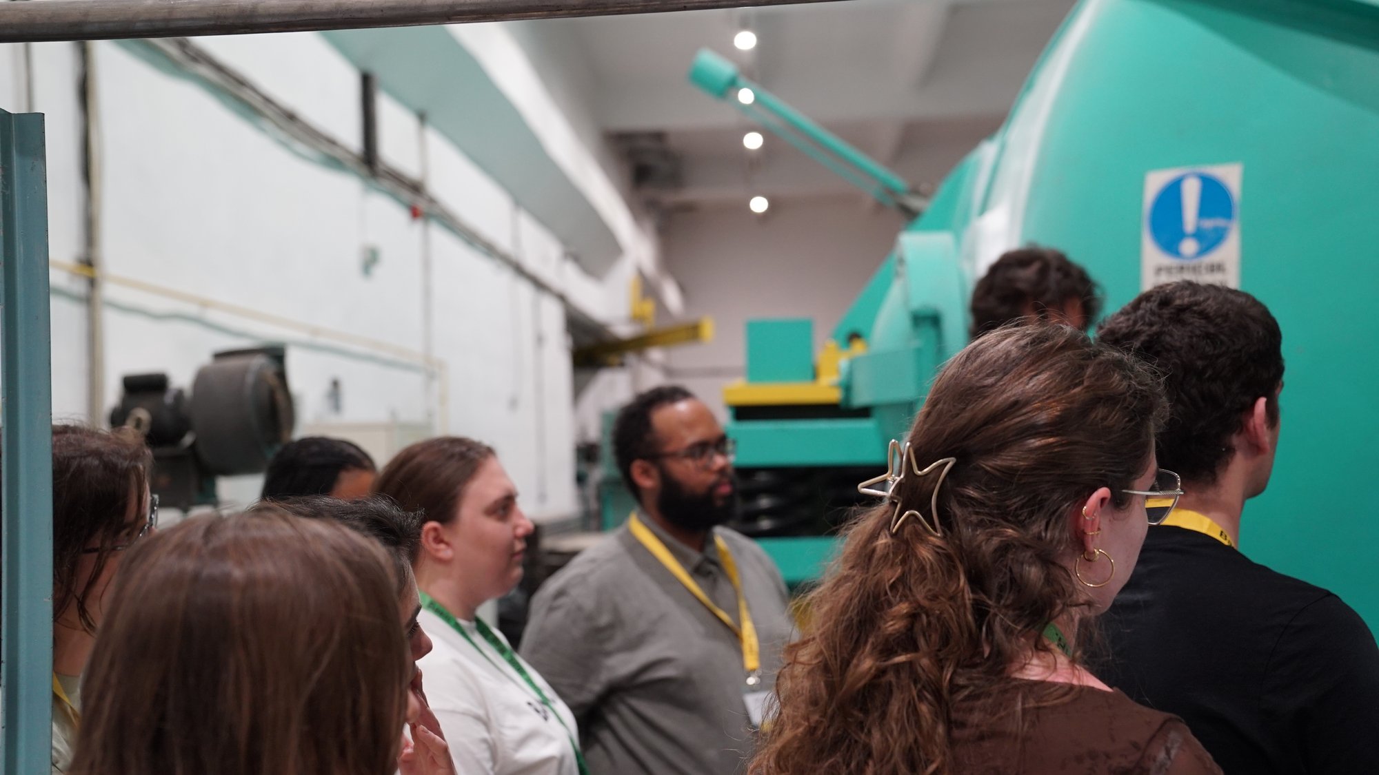 A trainer leads the group through the institute's corridors