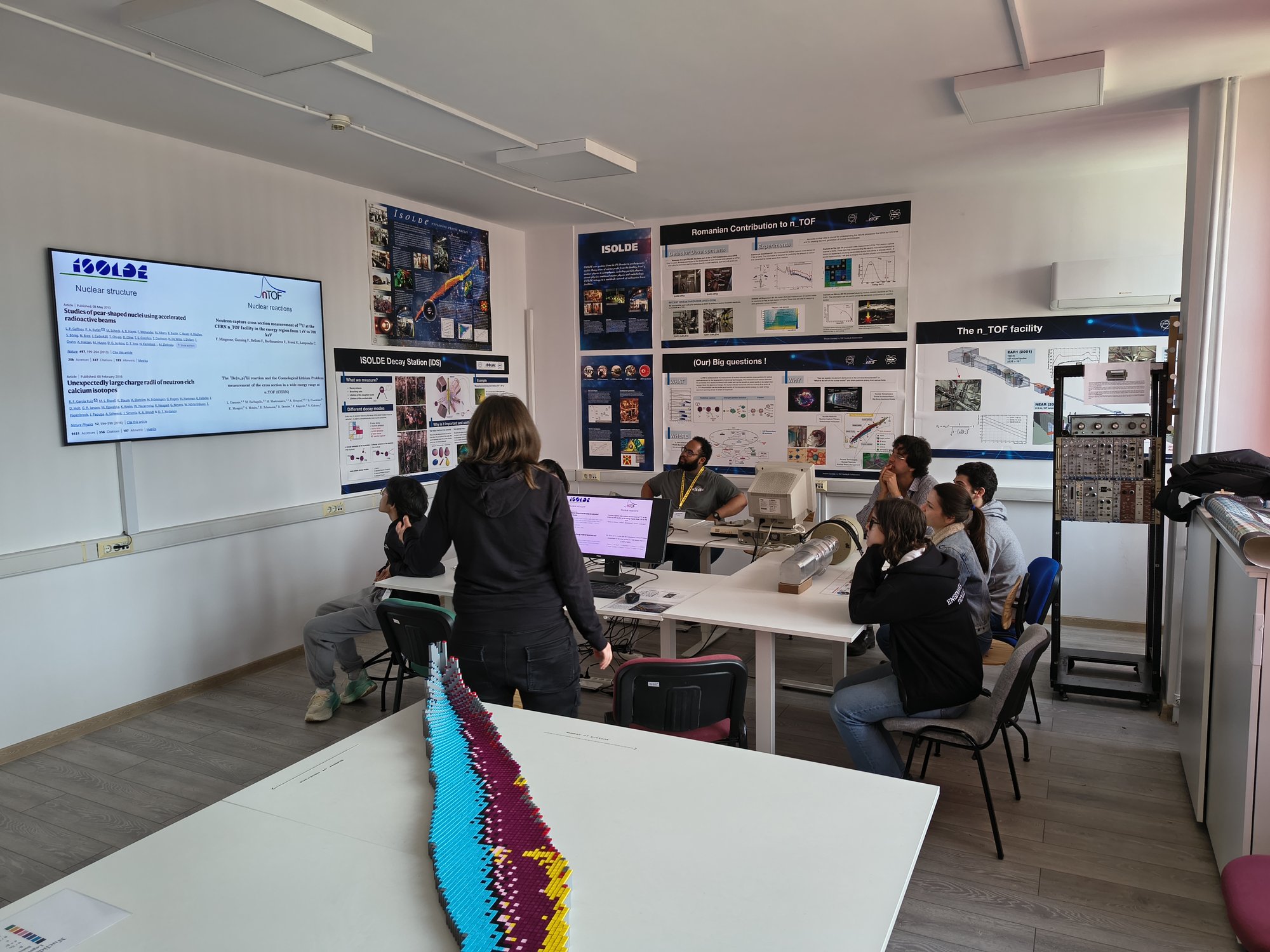 Trainees and a trainer at monitors in a specialised instrumentation lab
