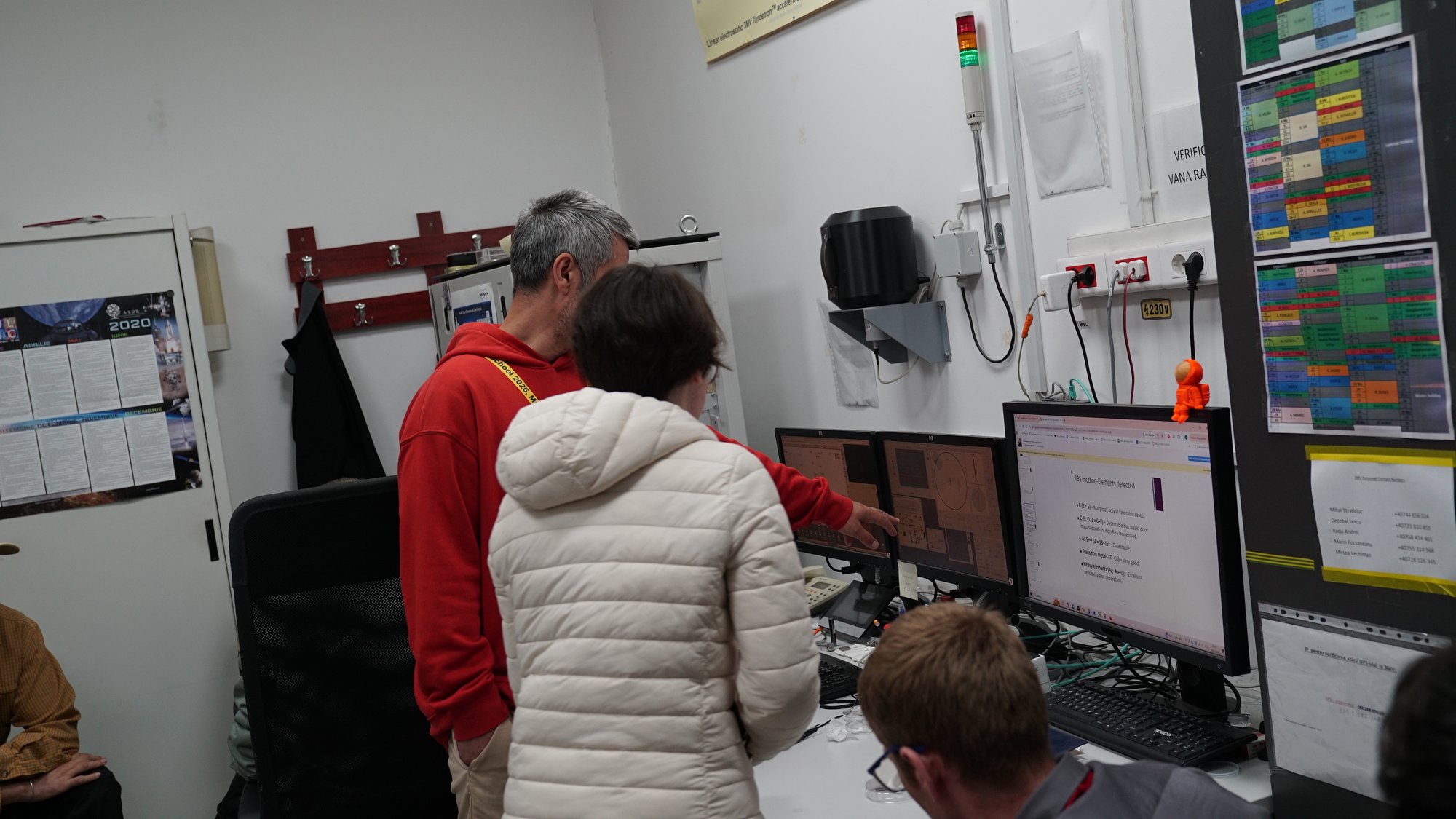 The group examines a large accelerator pressure vessel during a hands-on session