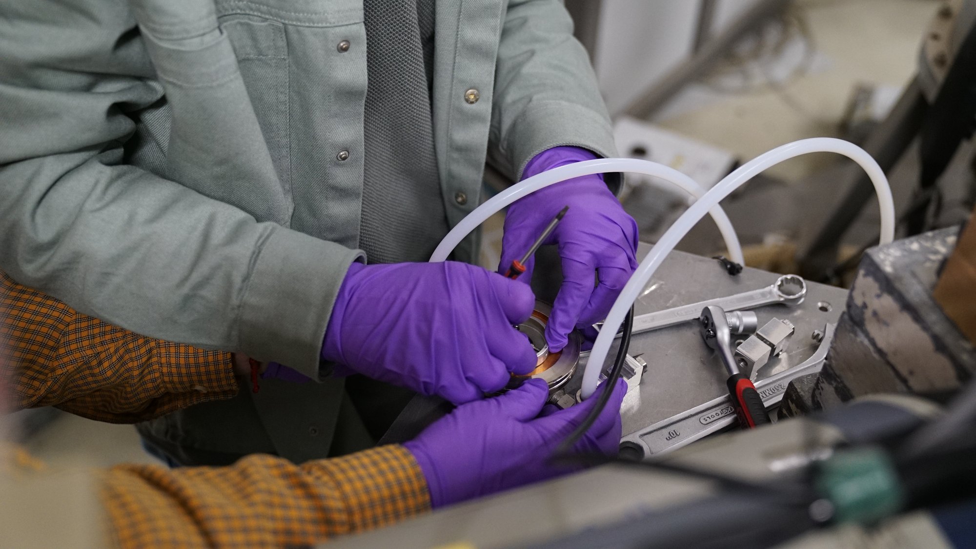 Gloved hands assembling a target frame during the target-preparation session
