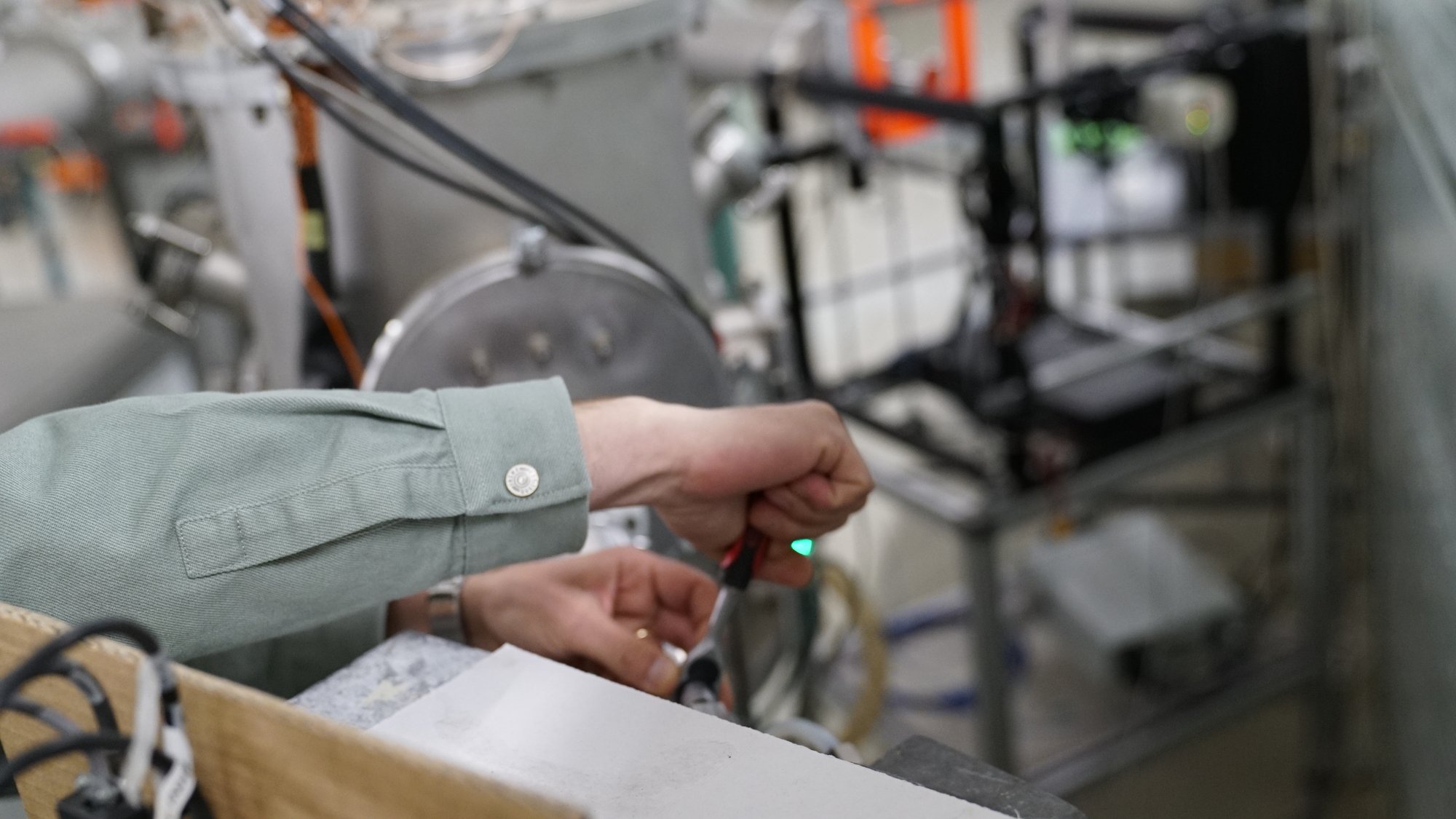 Trainees at a vacuum evaporation chamber during target preparation