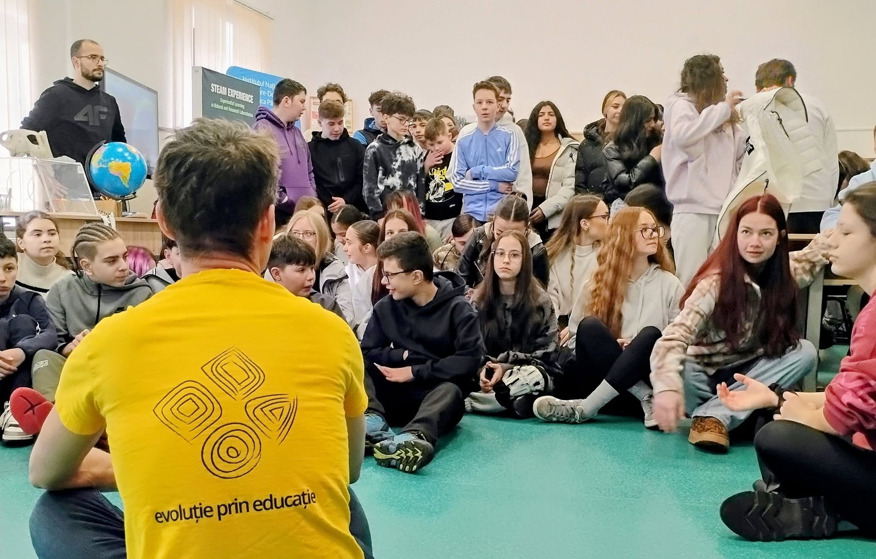 A DFNA researcher leading a STEAM session with a large group of school students