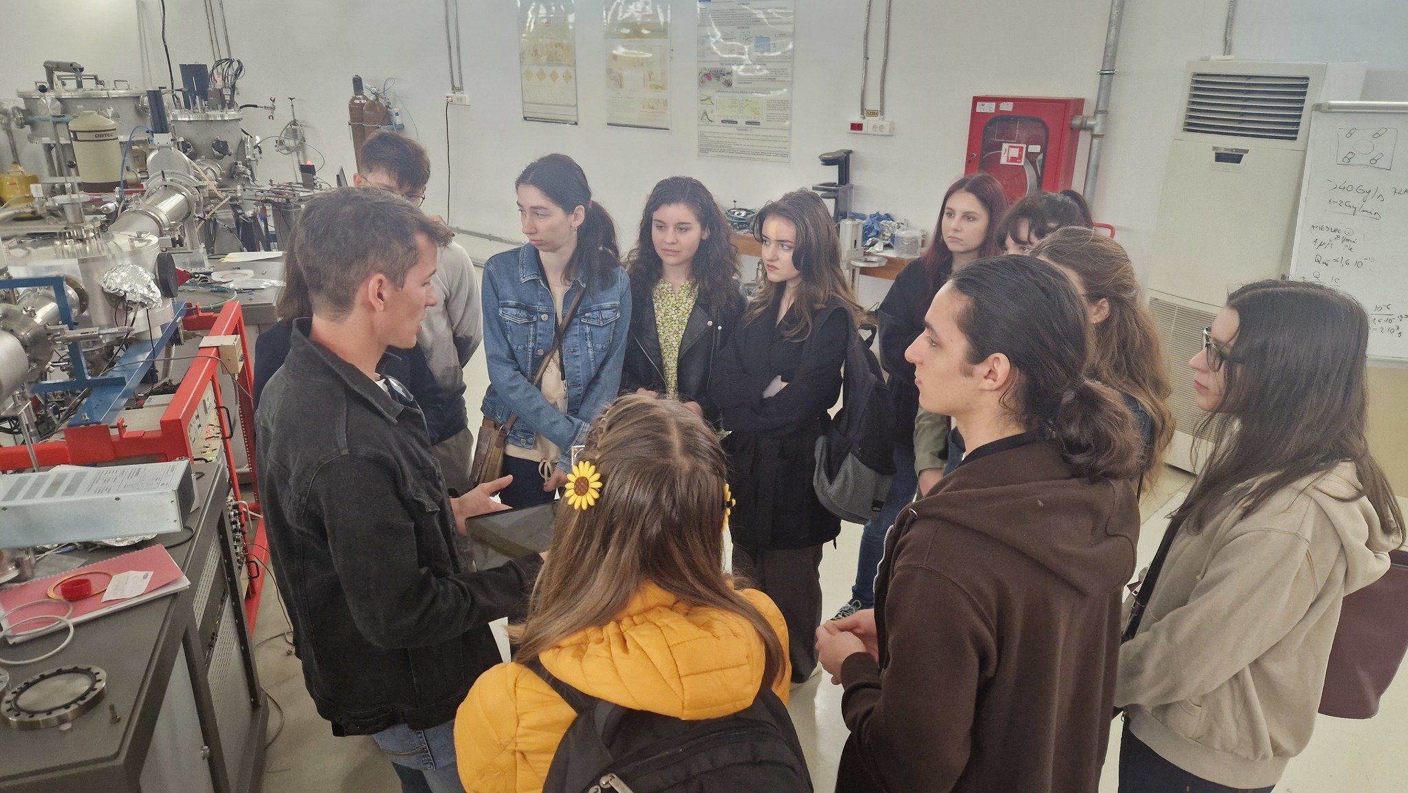 Visitors in front of one of the Tandetron accelerators
