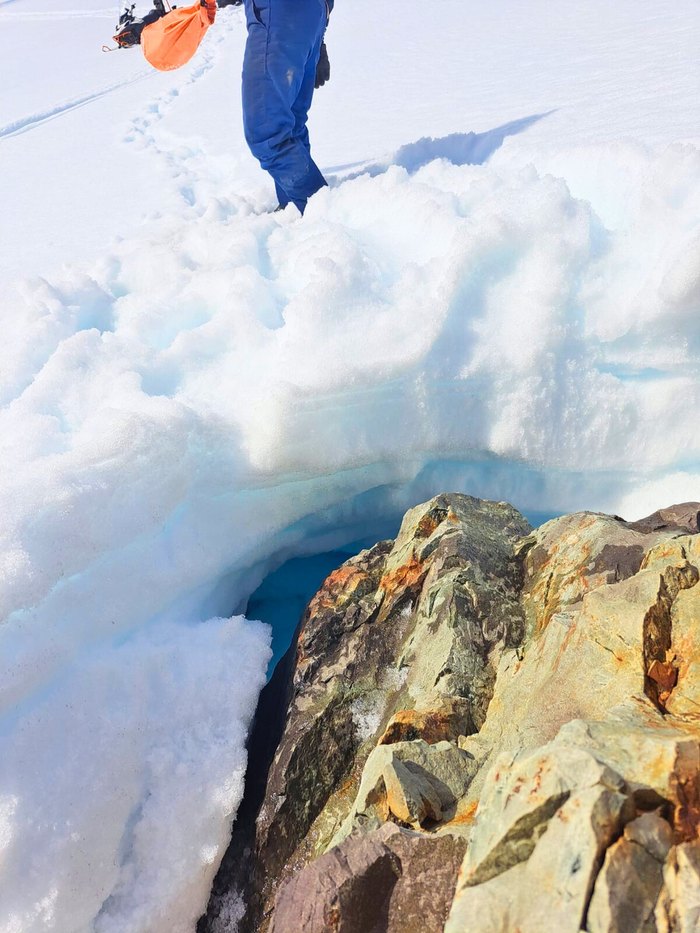 The edge of a glacier where blue ice meets weathered rock