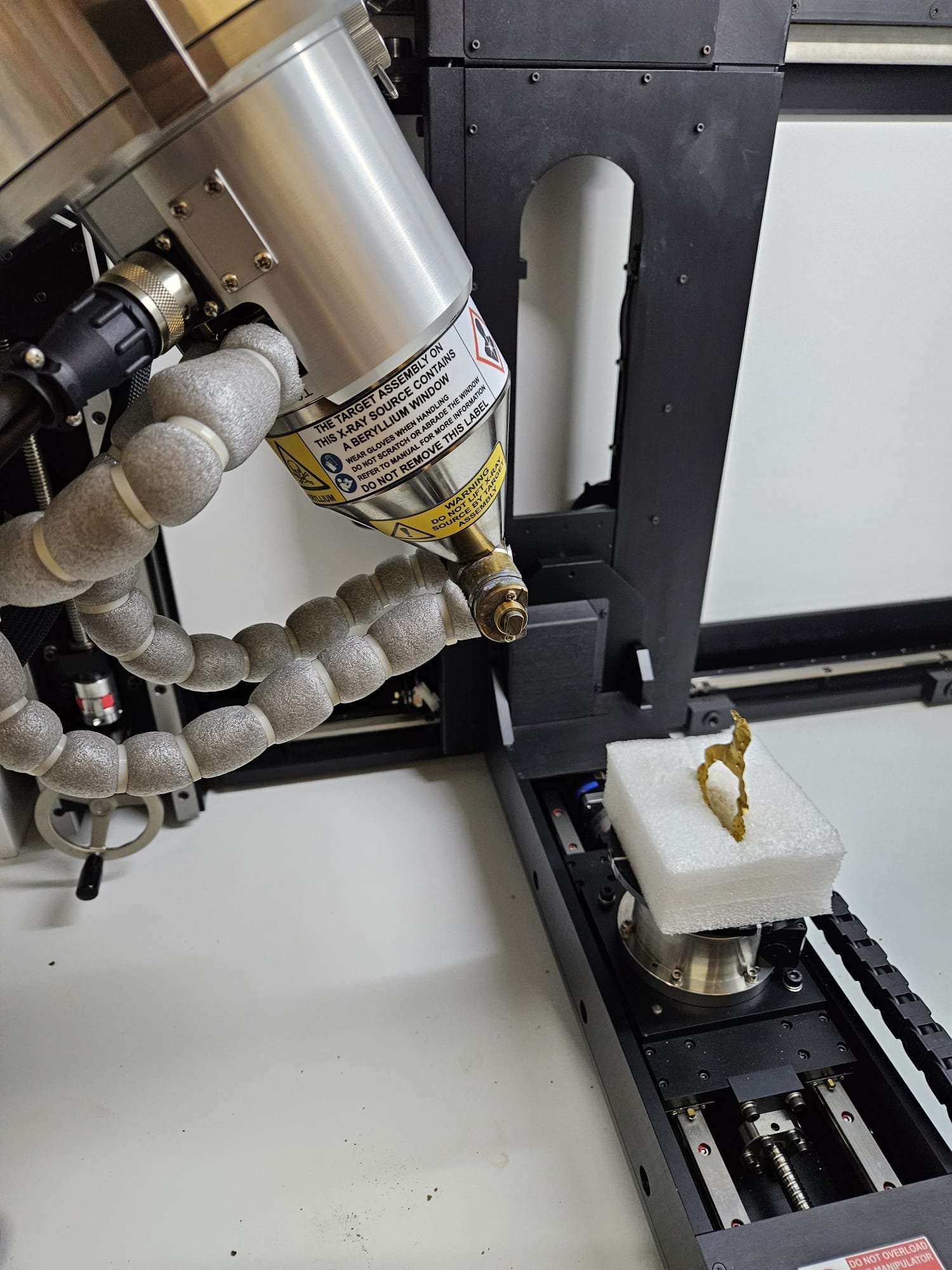 An archaeological metal object being analysed with an ion beam