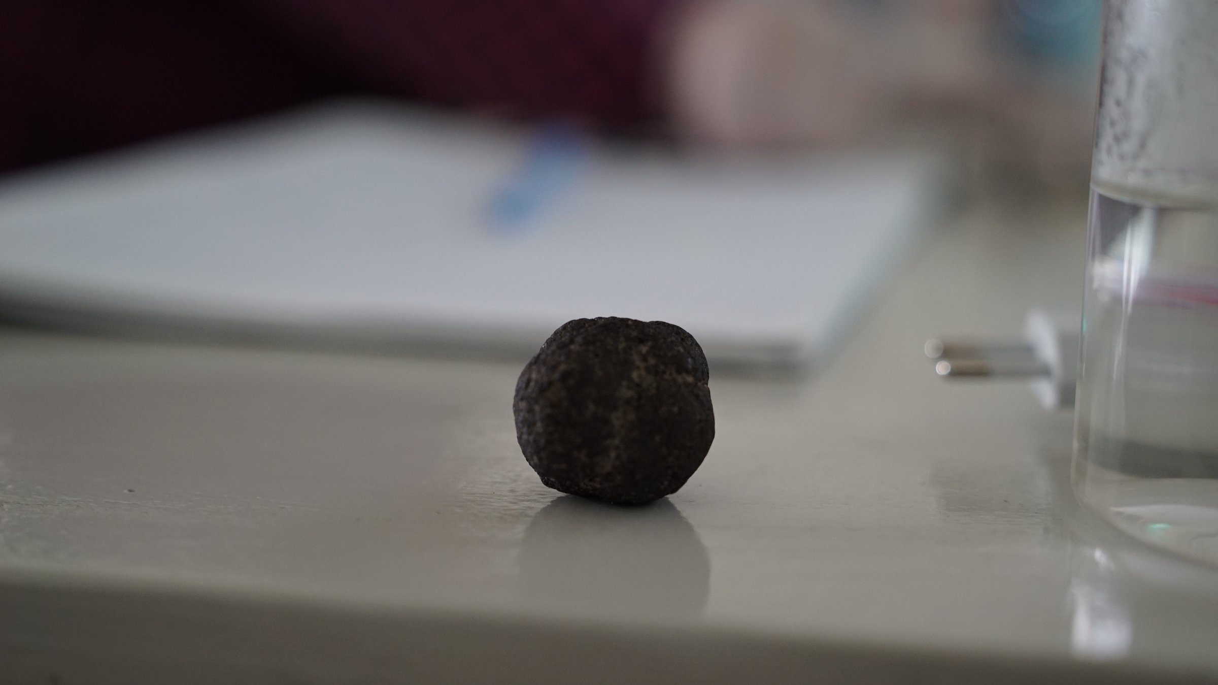 A spherical field sample resting on the lab bench during a RoAMS lab visit